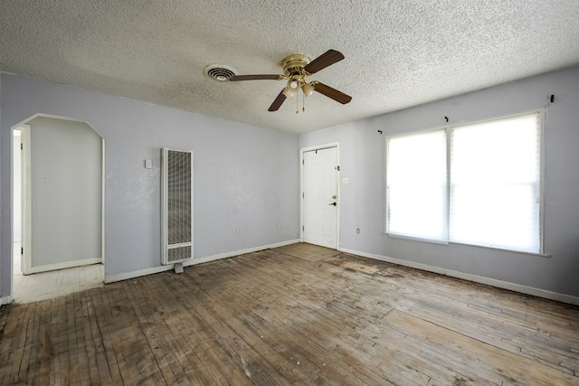 empty room with ceiling fan, a textured ceiling, and hardwood / wood-style flooring