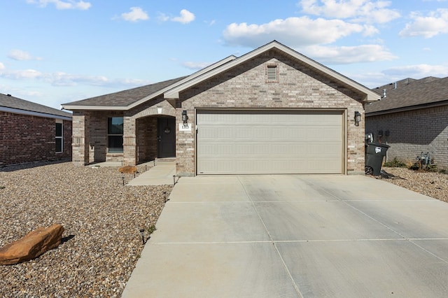 single story home featuring a garage, concrete driveway, and brick siding