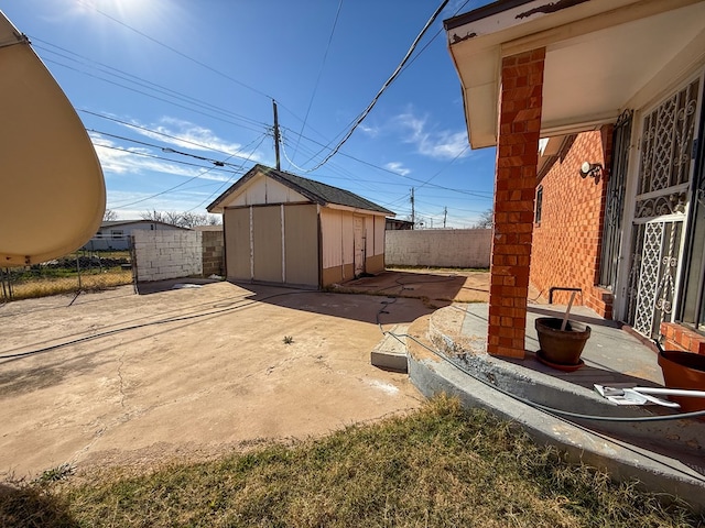 exterior space with a storage shed and a patio