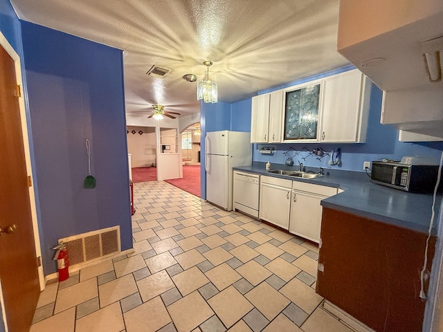 kitchen with white cabinets, decorative light fixtures, white appliances, and sink