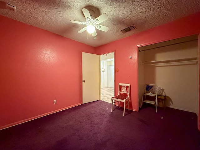 unfurnished bedroom with ceiling fan, a closet, carpet floors, and a textured ceiling