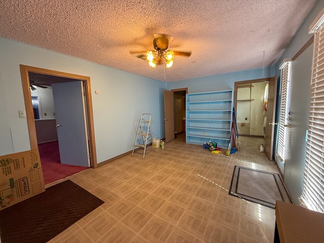 interior space featuring a textured ceiling and ceiling fan