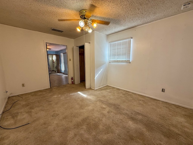 unfurnished room with carpet, a textured ceiling, and ceiling fan