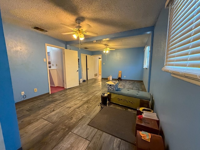 bedroom with a textured ceiling and ceiling fan