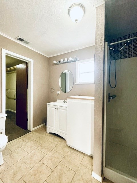 bathroom with vanity, ornamental molding, toilet, and walk in shower