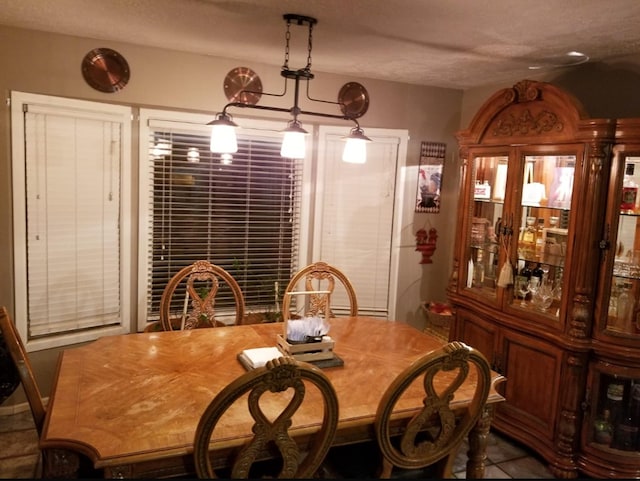 dining space featuring a textured ceiling