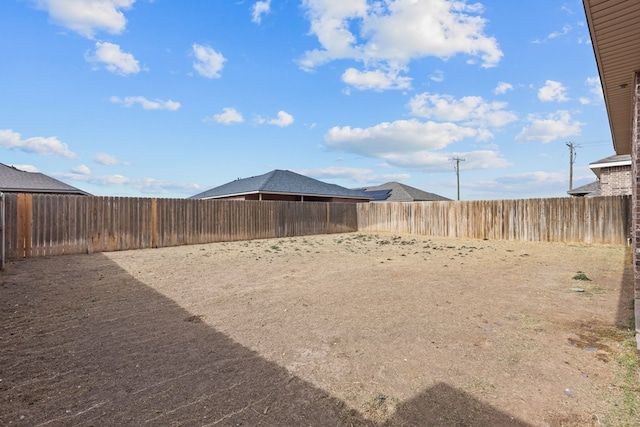 view of yard with a fenced backyard