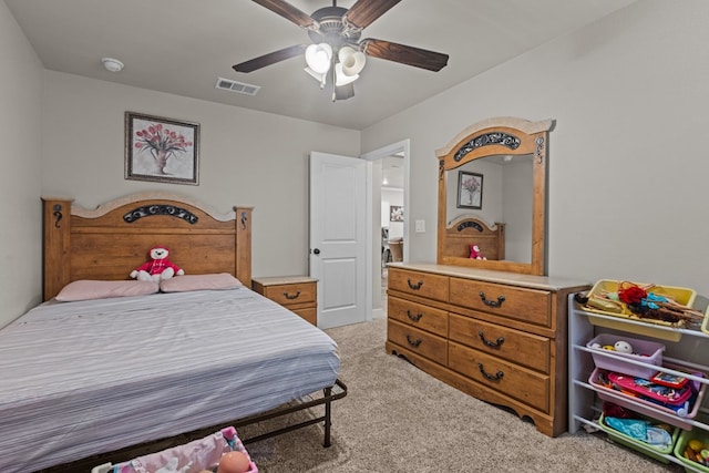 bedroom featuring visible vents, a ceiling fan, and light colored carpet