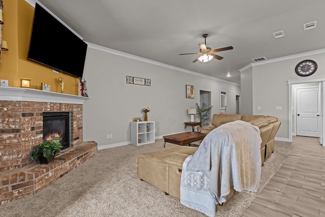 living area featuring visible vents, a fireplace, baseboards, and ceiling fan