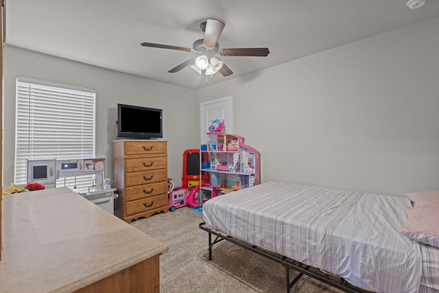 bedroom with a ceiling fan and light colored carpet