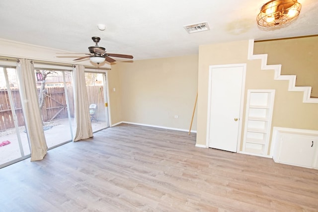 spare room featuring a textured ceiling, light hardwood / wood-style floors, and ceiling fan