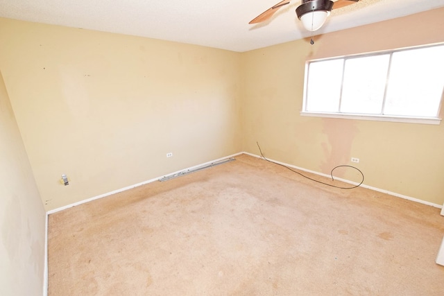 spare room with light carpet and ceiling fan