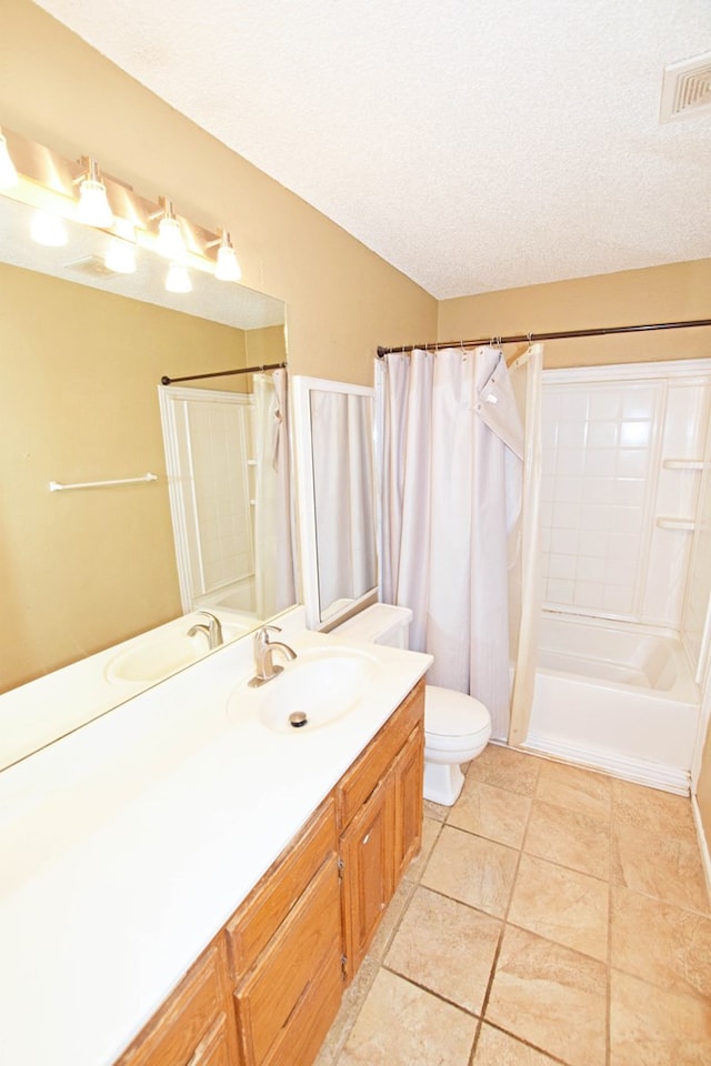 full bathroom featuring shower / tub combo, vanity, a textured ceiling, tile patterned floors, and toilet