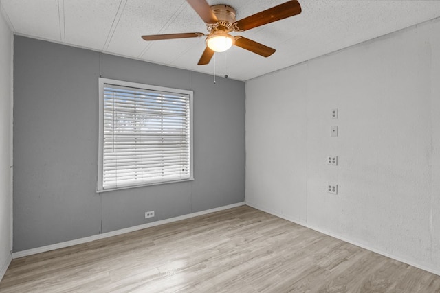 empty room with ceiling fan and light wood-type flooring