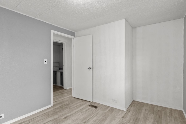 spare room featuring light wood-type flooring