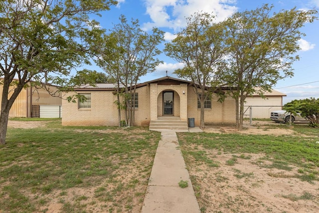 ranch-style home featuring a garage and a front lawn