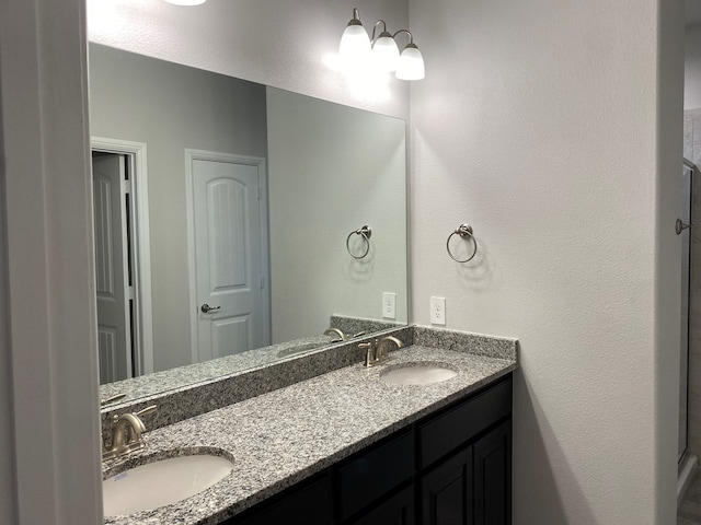 bathroom featuring a sink and double vanity