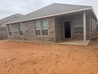 rear view of property featuring a patio area