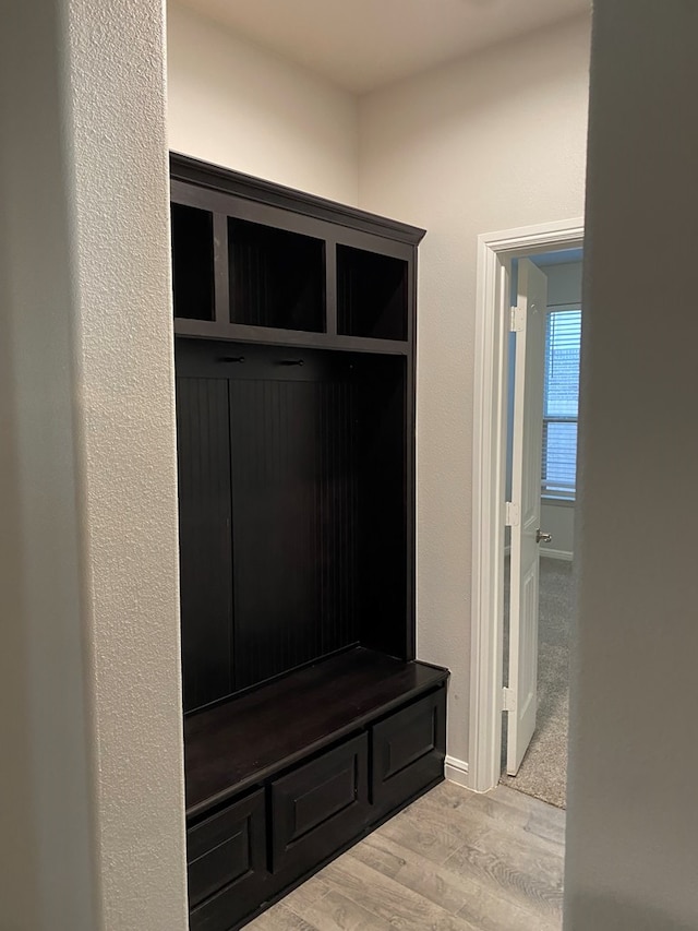 mudroom with baseboards and wood finished floors