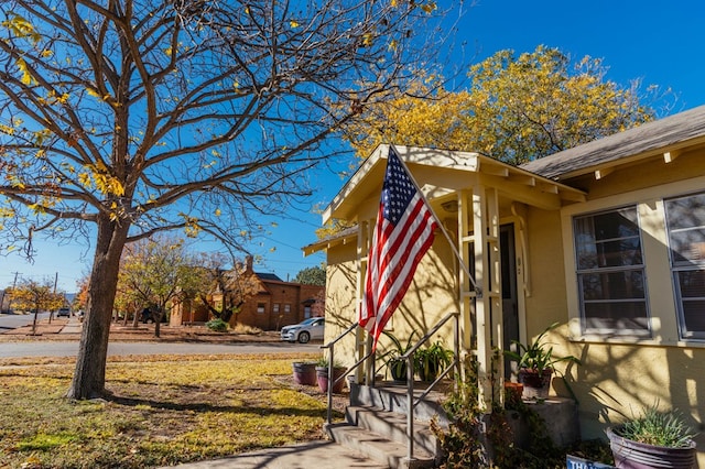 view of side of property with a lawn