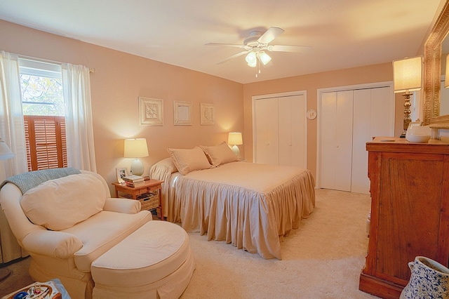 carpeted bedroom with multiple closets and ceiling fan