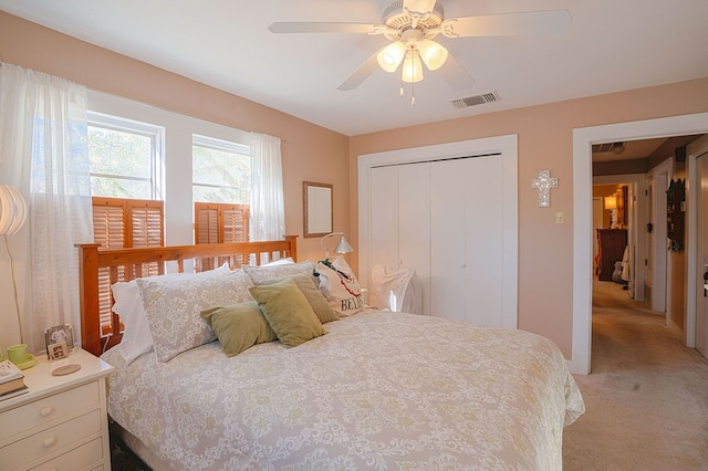 carpeted bedroom featuring ceiling fan and a closet