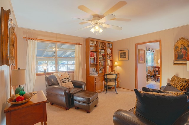 interior space with light carpet and ceiling fan