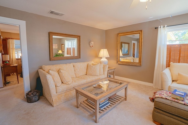 carpeted living room featuring ceiling fan