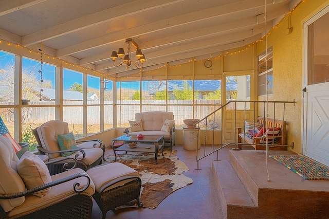 sunroom with a chandelier and lofted ceiling with beams