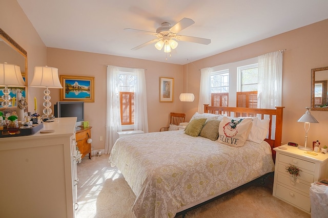 bedroom featuring ceiling fan and light carpet