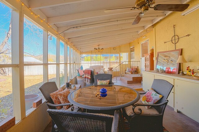 sunroom / solarium with ceiling fan and lofted ceiling with beams