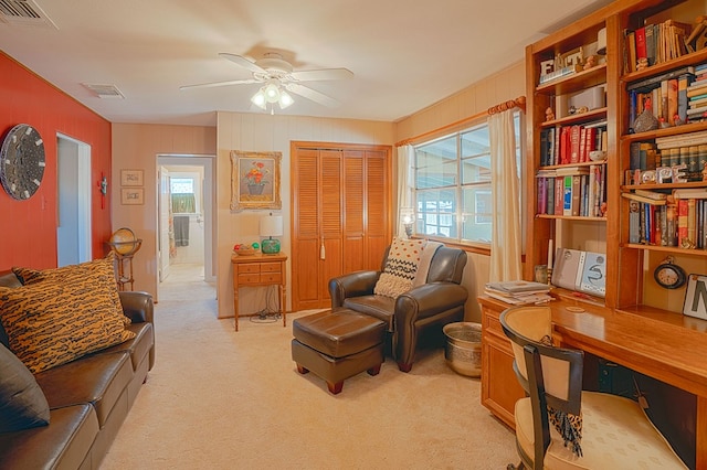 sitting room featuring light carpet and ceiling fan