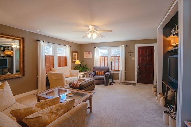 living room with light colored carpet, ceiling fan, and a healthy amount of sunlight