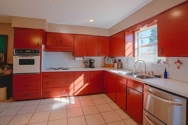 kitchen featuring decorative backsplash, light tile patterned floors, white appliances, and sink