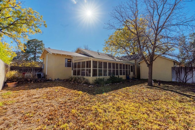 rear view of house featuring a sunroom