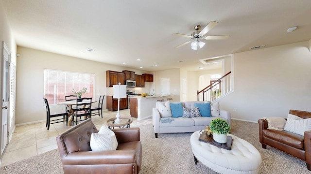 tiled living room with ceiling fan