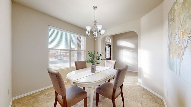 tiled dining area featuring a notable chandelier