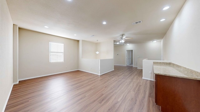 empty room with hardwood / wood-style floors and ceiling fan