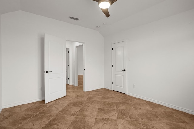 empty room with ceiling fan and vaulted ceiling