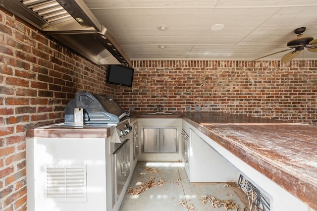 view of patio / terrace featuring an outdoor kitchen, ceiling fan, sink, and grilling area