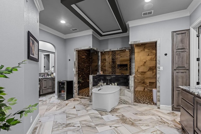 bathroom featuring vanity, shower with separate bathtub, and ornamental molding