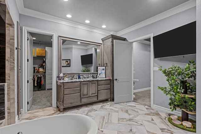 bathroom featuring vanity, a washtub, and crown molding