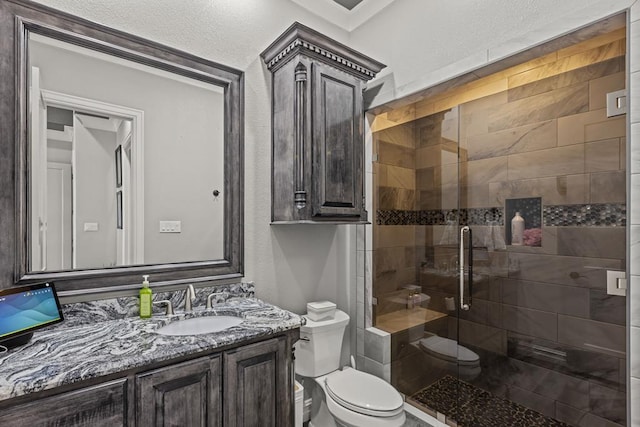 bathroom featuring vanity, toilet, and an enclosed shower