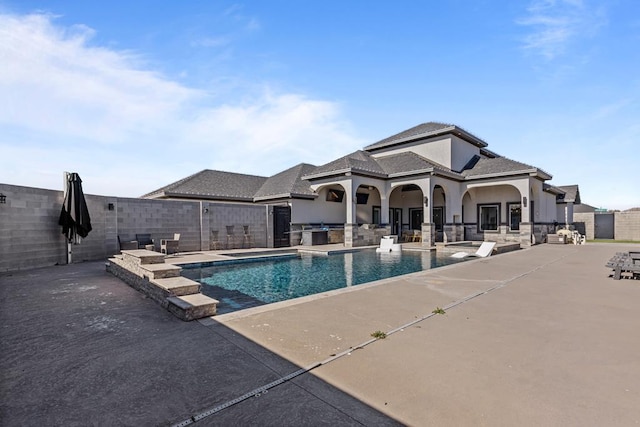 view of pool with a patio area and exterior kitchen