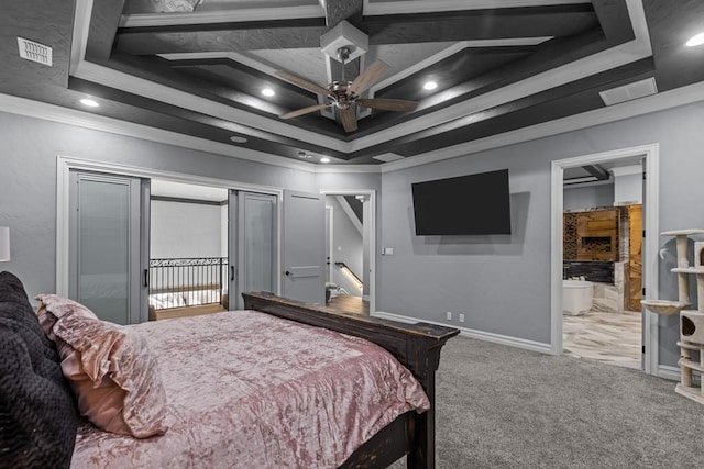 carpeted bedroom with ornamental molding and a tray ceiling