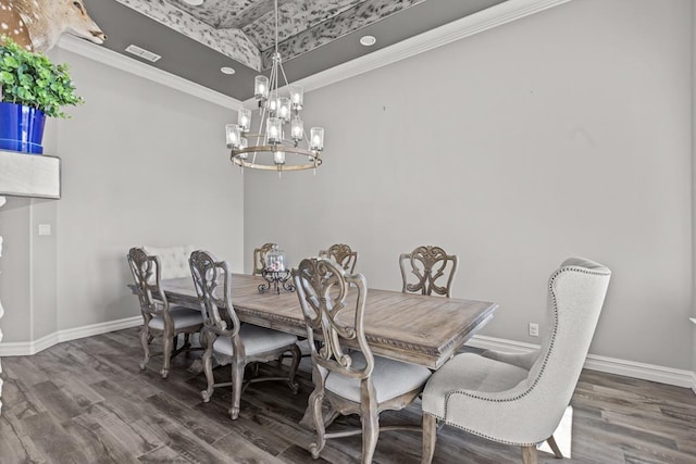 dining room featuring an inviting chandelier, ornamental molding, and dark hardwood / wood-style floors