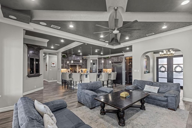 living room with crown molding, ceiling fan, french doors, and hardwood / wood-style flooring