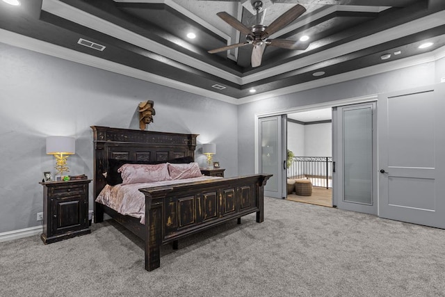 bedroom with crown molding, light colored carpet, a raised ceiling, and ceiling fan