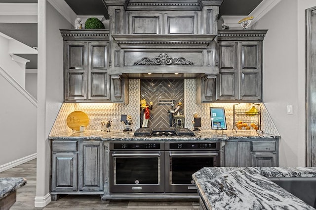 kitchen featuring ornamental molding, dark hardwood / wood-style flooring, light stone countertops, and backsplash