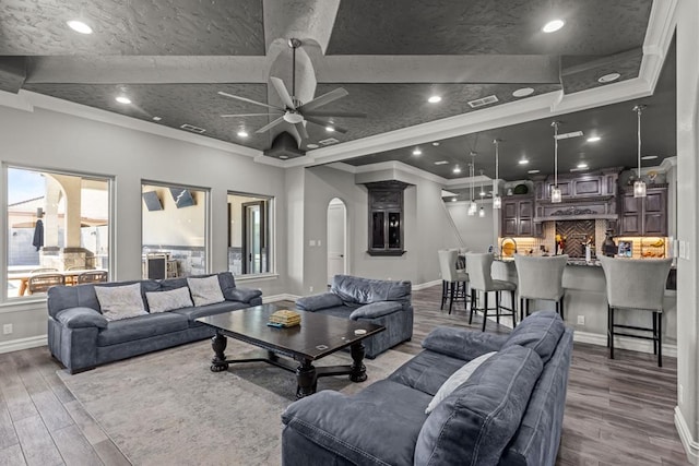 living room featuring crown molding, hardwood / wood-style flooring, and ceiling fan